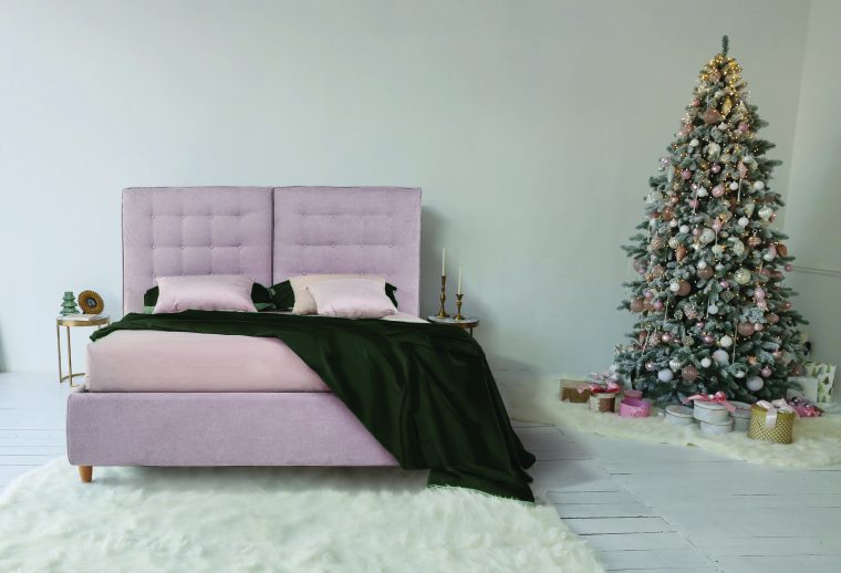 Elegant Christmas tree with white and pink toys in the bedroom o